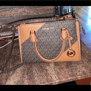 Michael Kors purse with strap.